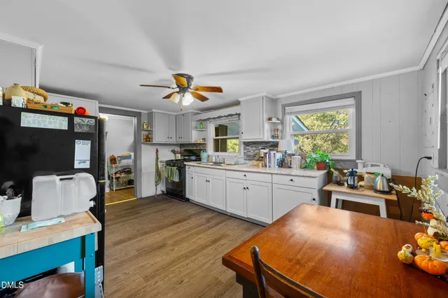 a kitchen that has a table and chairs in it