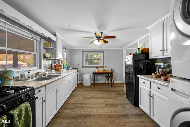 a kitchen with a stove a sink and a refrigerator