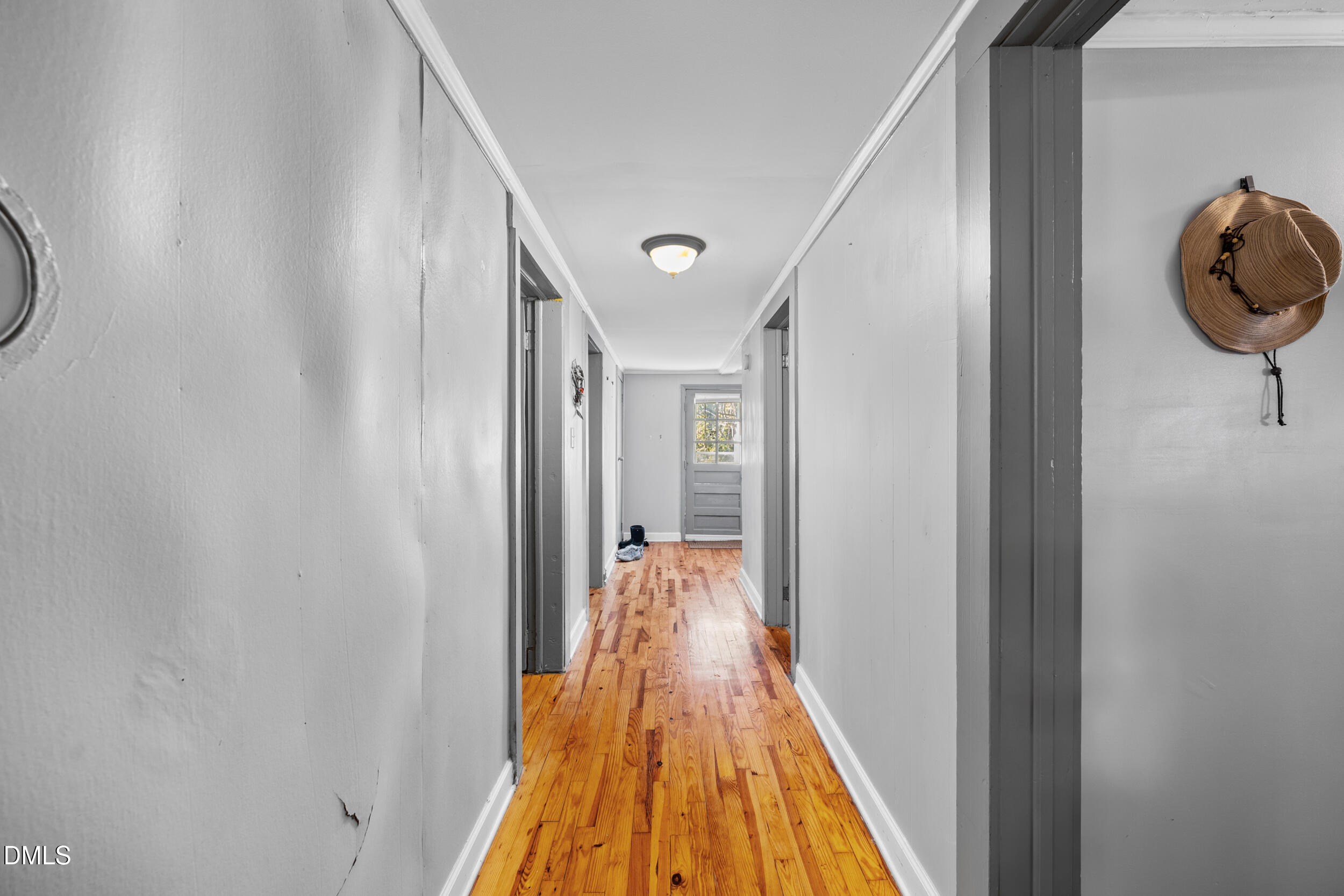 2707 Moorefields Road Hillsborough, NC 27278 - Photo 8 of 36 a view of a hallway with wooden floor and staircase
