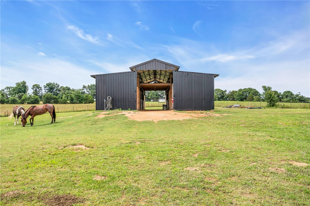 615 Wilson Road Central, SC 29630 - Photo 4 of 50 A spacious barn stands in the center of lush green pasture land.