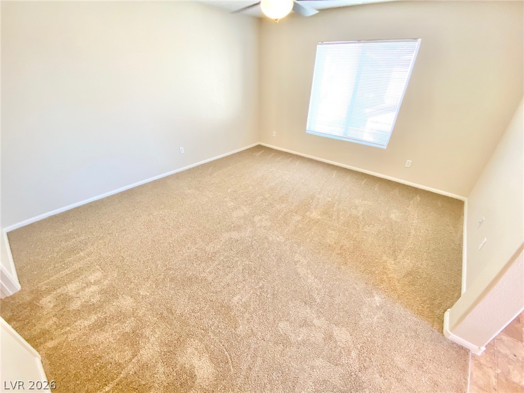 8569 Rhamus Court Las Vegas, NV 89149 - Photo 22 of 35 A spacious room offers comfortable carpeting and a wide window for natural light.