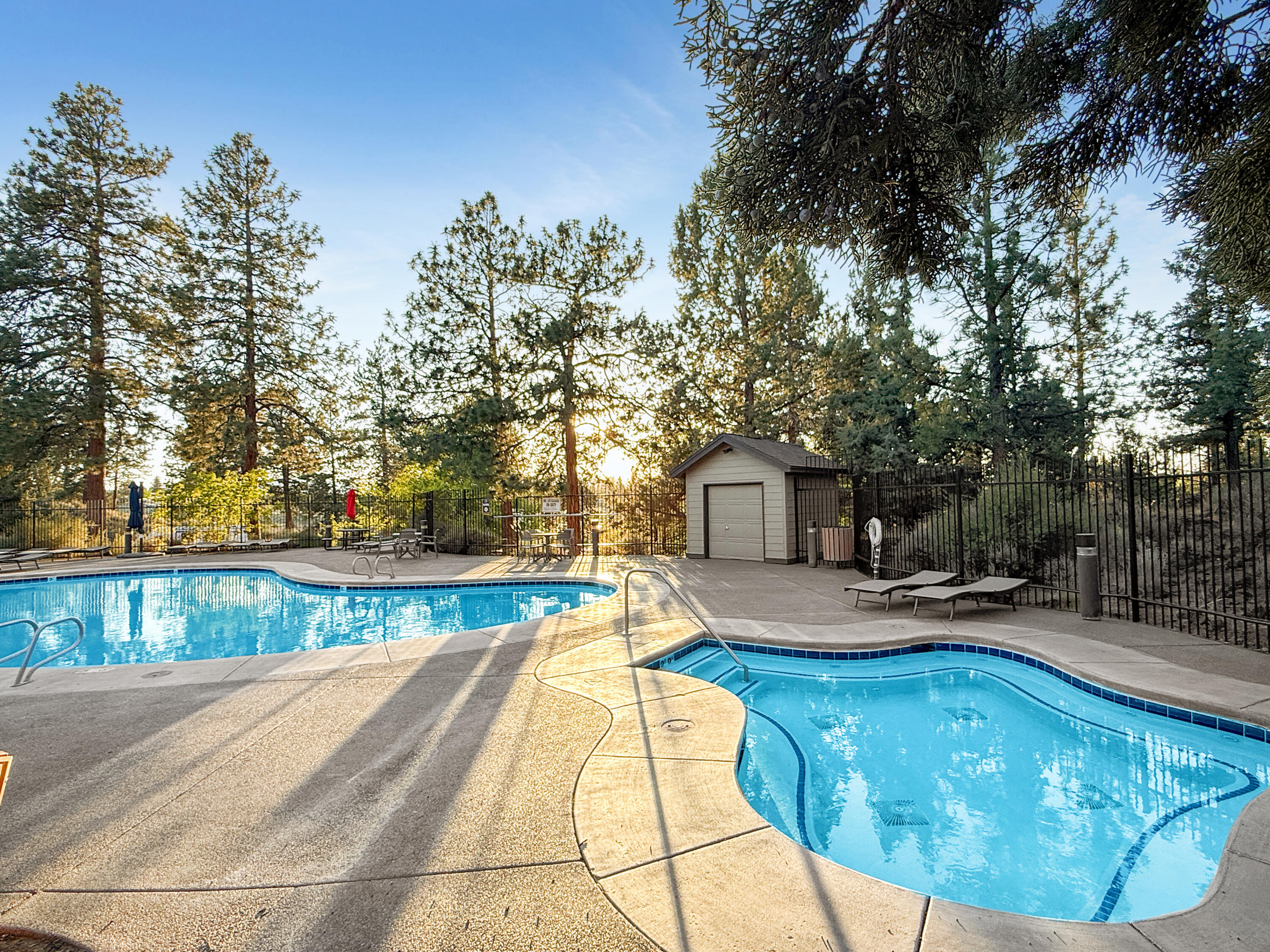 61072 Manhae Loop Bend, OR 97702 - Photo 60 of 63 a view of swimming pool with seating area and trees around