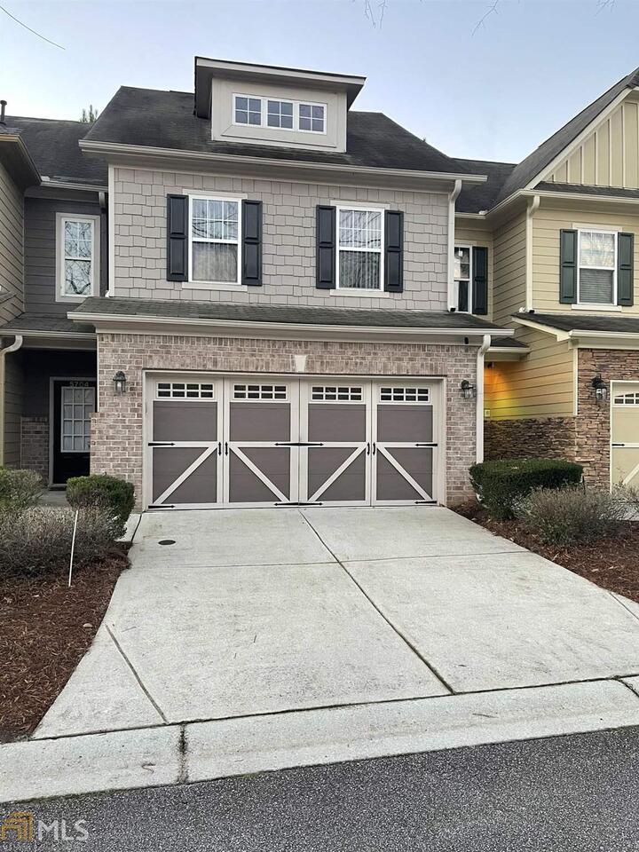 a front view of a house with garage