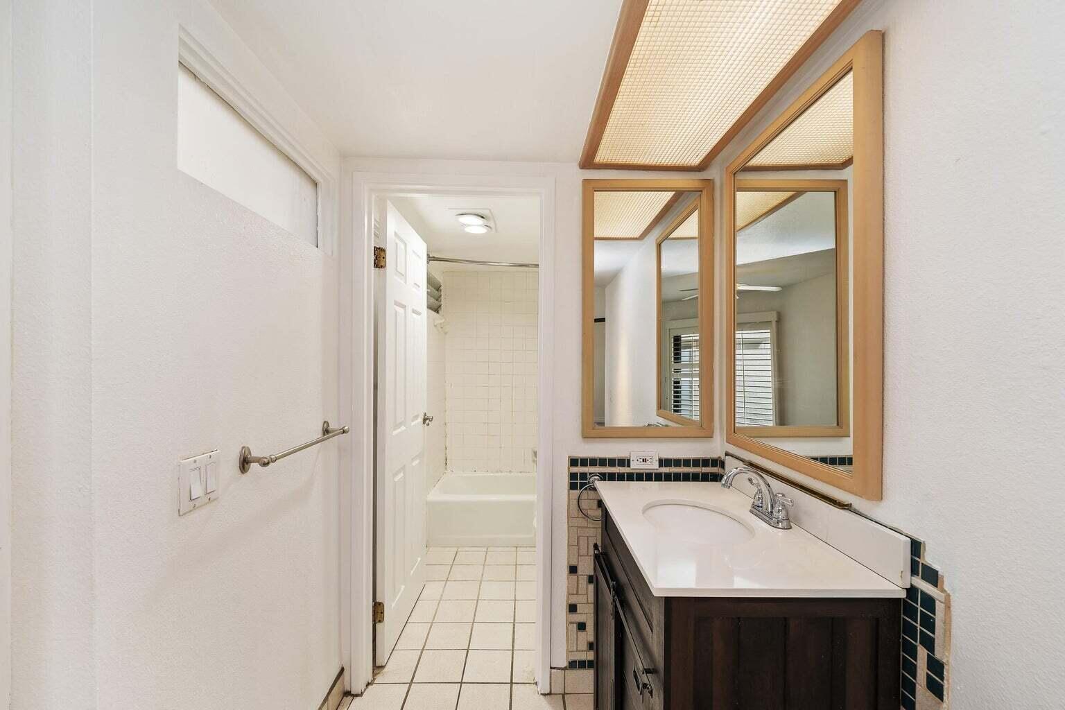 71861 Eleanora Lane Rancho Mirage, CA 92270 - Photo 11 of 22 a bathroom with a sink a mirror and a shower