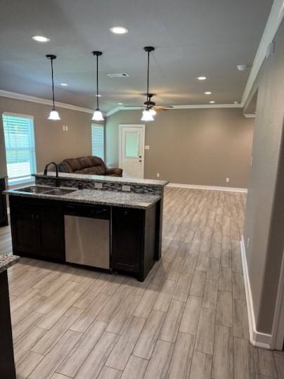611 Foxmeadows Lane Cleveland, TX 77327 - Photo 12 of 13 a kitchen with stainless steel appliances granite countertop a sink a stove and a wooden floors