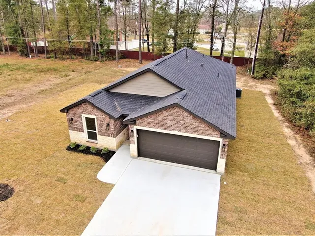 a pathway of a house with a yard