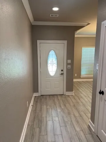 an empty room with wooden floor and a window
