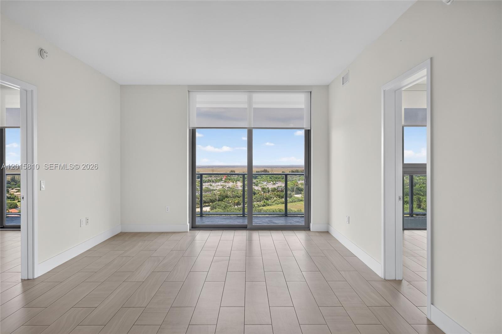 2000 Metropica Way, Unit 1902 Sunrise, FL 33323 - Photo 11 of 40 wooden floor in an empty room with a window