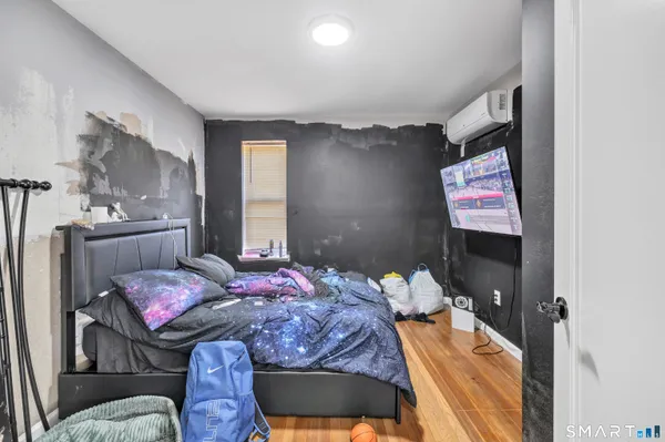 a bedroom with a bed and glass windows