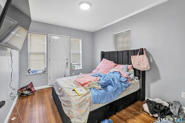 a bedroom with a bed and a window