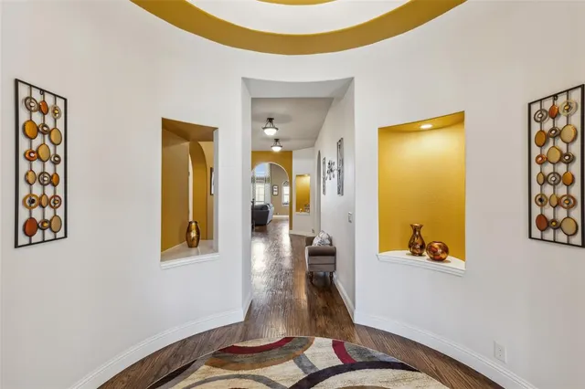 a view of a hallway with wooden floor and dining room