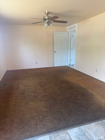 992 300 East Orem, UT 84057 - Photo 6 of 7 Spacious room with plush brown carpeting and light-toned walls