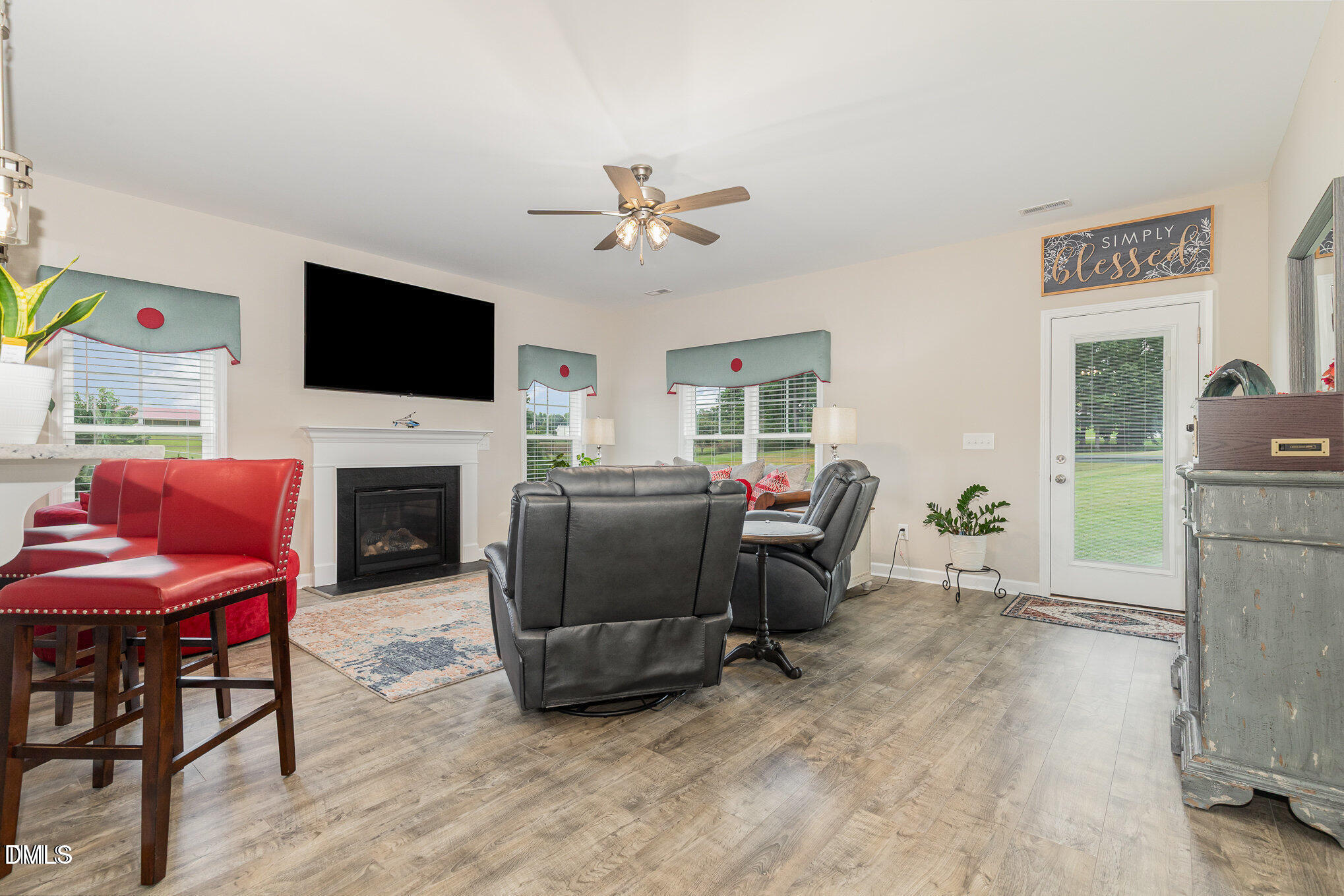 8662 Buckhorn Plantation Road Sims, NC 27880 - Photo 11 of 37 a living room with furniture a fireplace and a flat screen tv