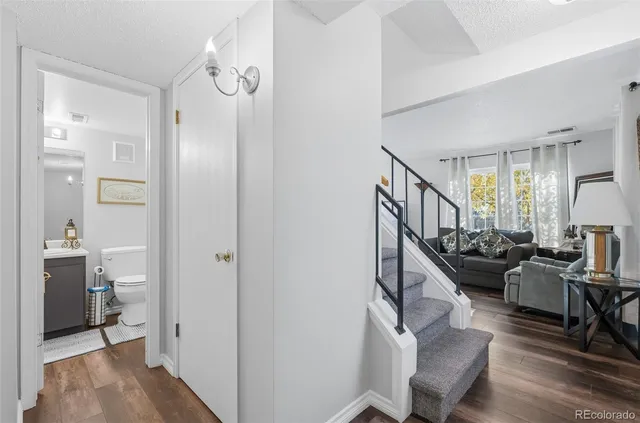 a living room with furniture and a dining table
