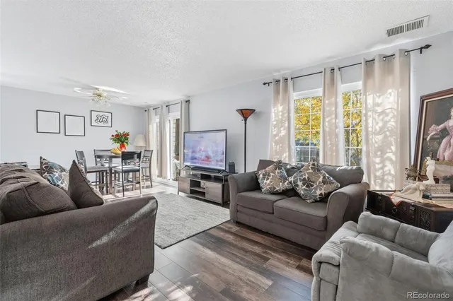 a living room with furniture and wooden floor