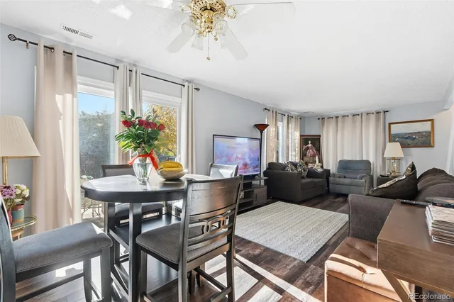 a view of a dining room with furniture a chandelier and a rug