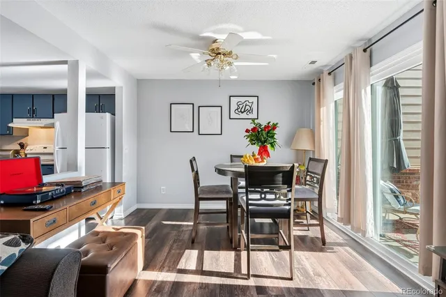 a living room with furniture and a kitchen view