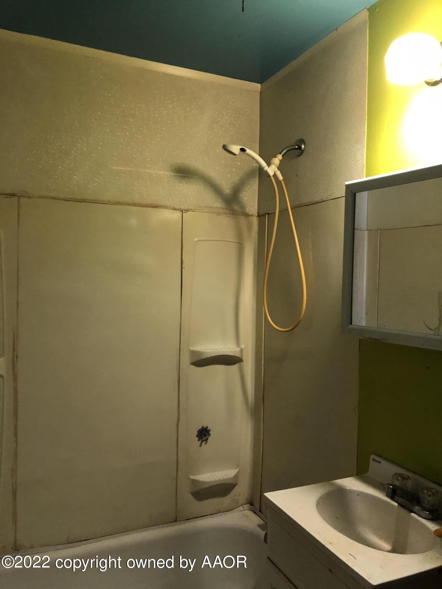309 Southwest 45th Avenue Amarillo, TX 79110 - Photo 3 of 6 a bathroom with a shower a toilet and sink