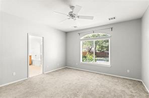 10708 Sycamore Hills Road Austin, TX 78717 - Photo 7 of 10 an empty room with a window and a ceiling fan