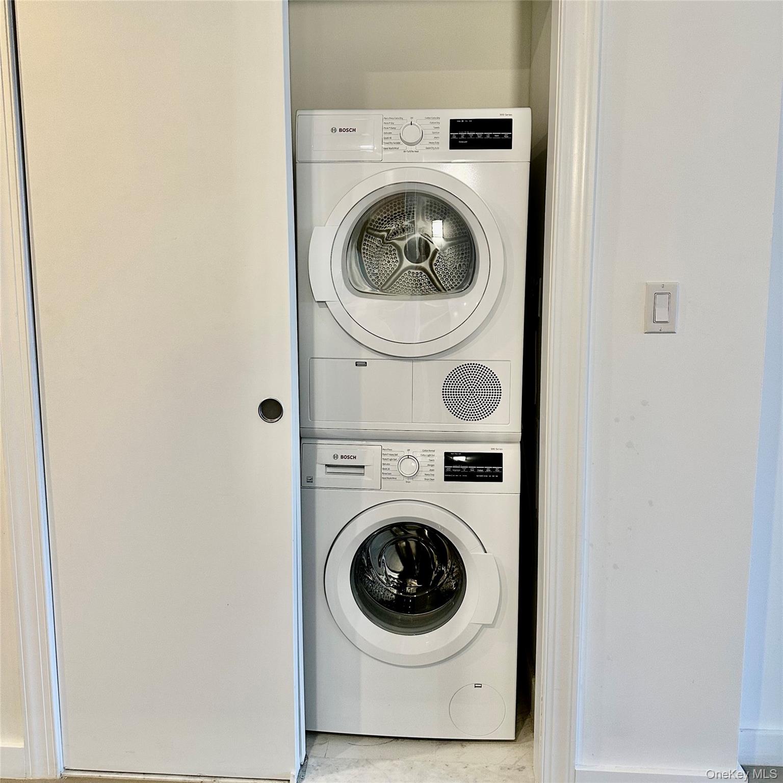 8808 Justice Avenue, Unit 13M Queens, NY 11373 - Photo 3 of 11 a utility room with dryer and washer