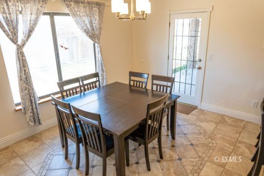 644 Beth Lane Ridgecrest, CA 93555 - Photo 8 of 31 a view of a dining room with furniture and a window