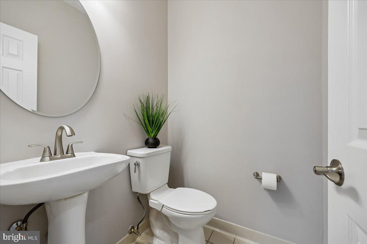 21712 Slidell Road Boyds, MD 20841 - Photo 31 of 32 a bathroom with a toilet a sink and a mirror