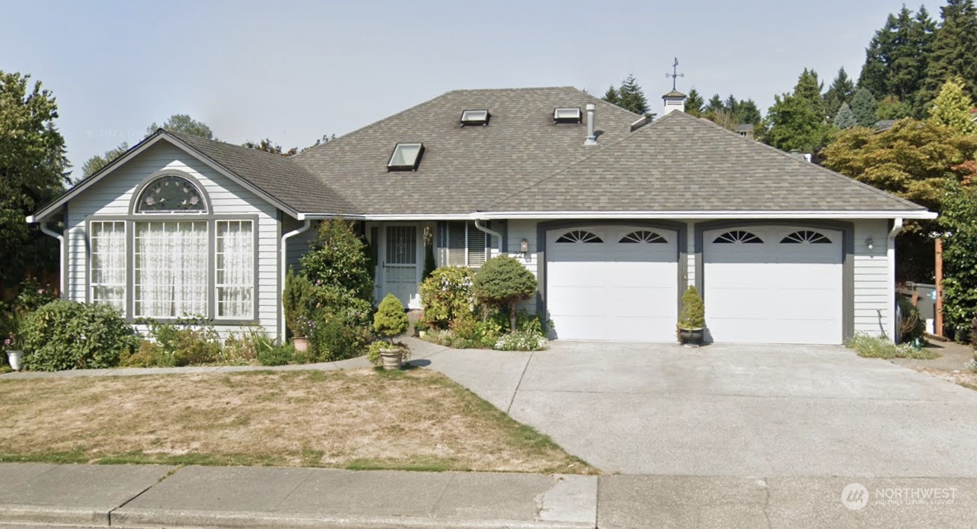 227 Powell Avenue Southwest Renton, WA 98057 - Photo 1 of 1 a front view of a house with a yard and garage
