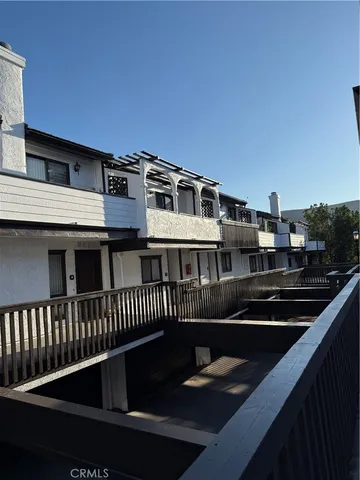 a view of a roof deck with chair and wooden floor