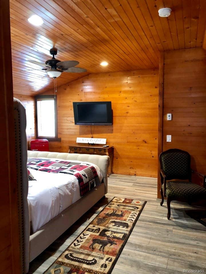 121 Claudius Road Black Hawk, CO 80422 - Photo 15 of 29 a bedroom with a bed and wooden floor