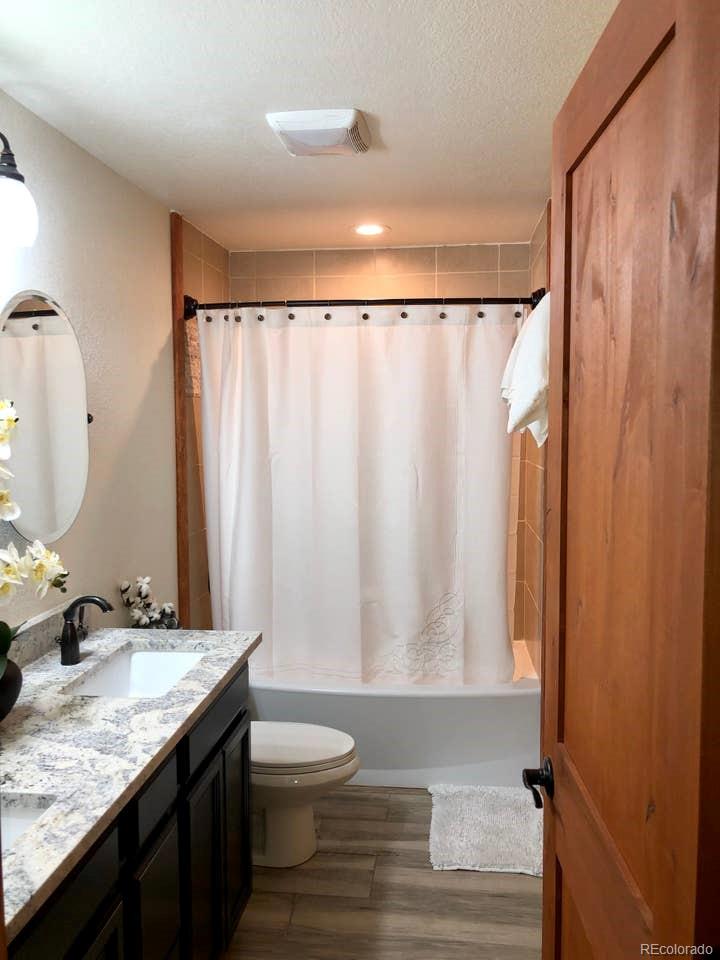 121 Claudius Road Black Hawk, CO 80422 - Photo 19 of 29 a bathroom with a granite countertop sink and a mirror