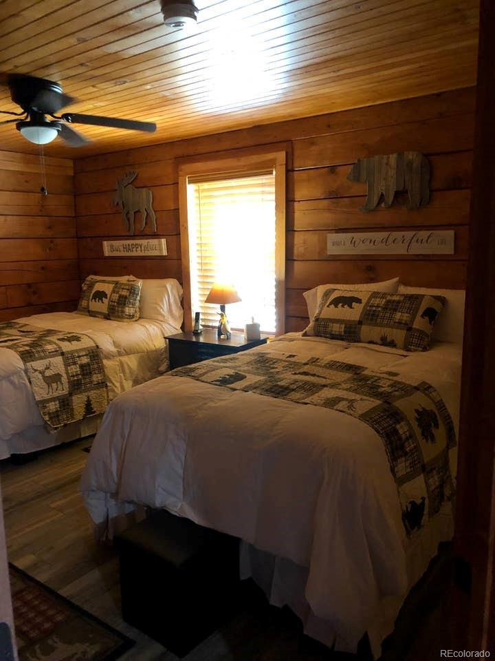 121 Claudius Road Black Hawk, CO 80422 - Photo 3 of 29 a bedroom with two beds and a window