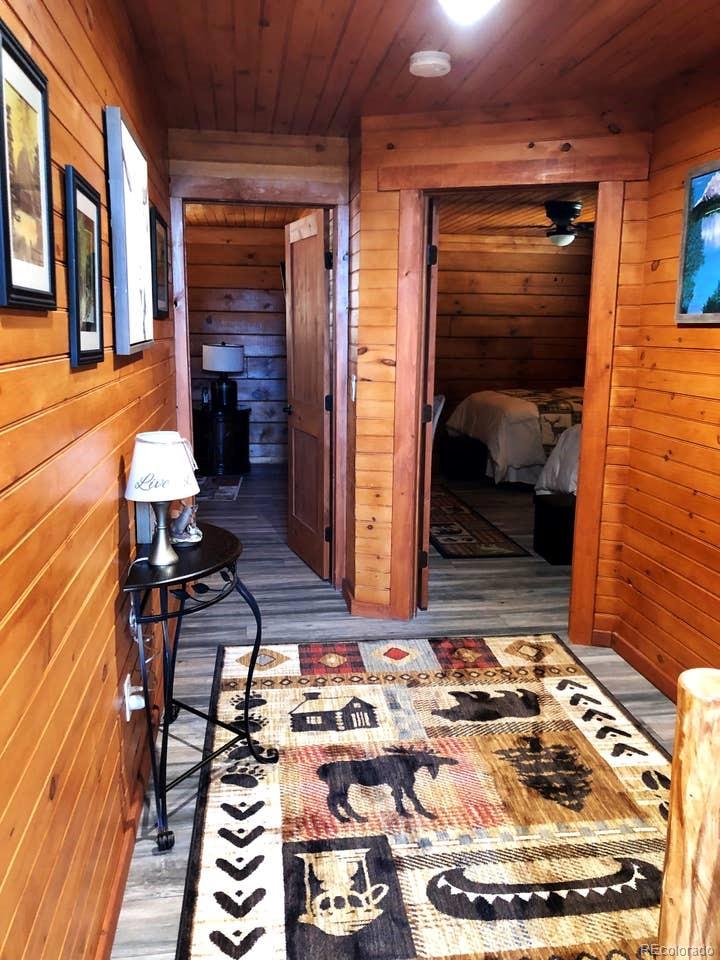 121 Claudius Road Black Hawk, CO 80422 - Photo 6 of 29 a living room with fireplace furniture and a wooden floor