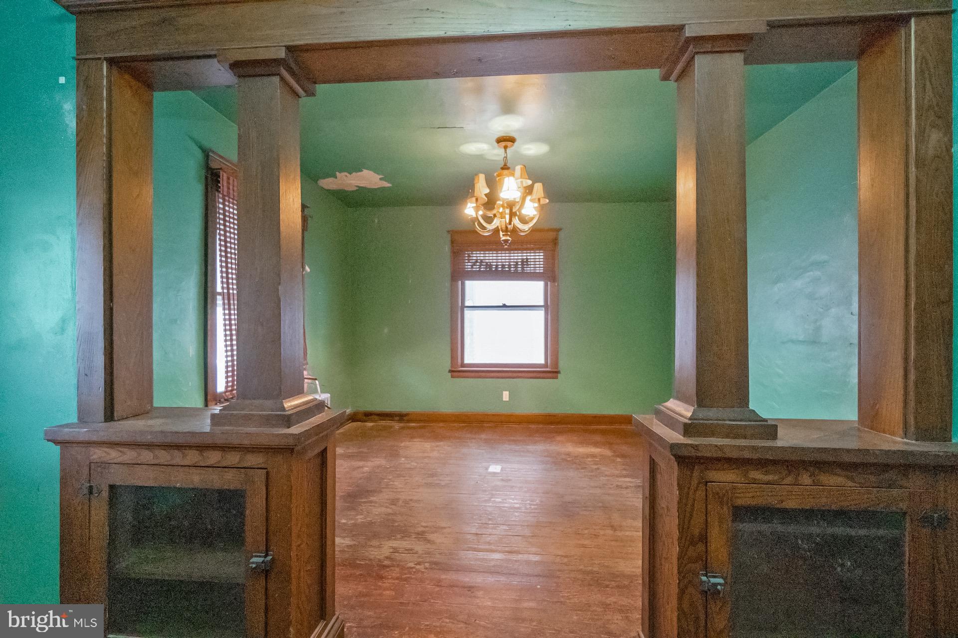 446 Williams Street Easton, PA 18042 - Photo 11 of 37 a room with a fireplace windows and a chandelier