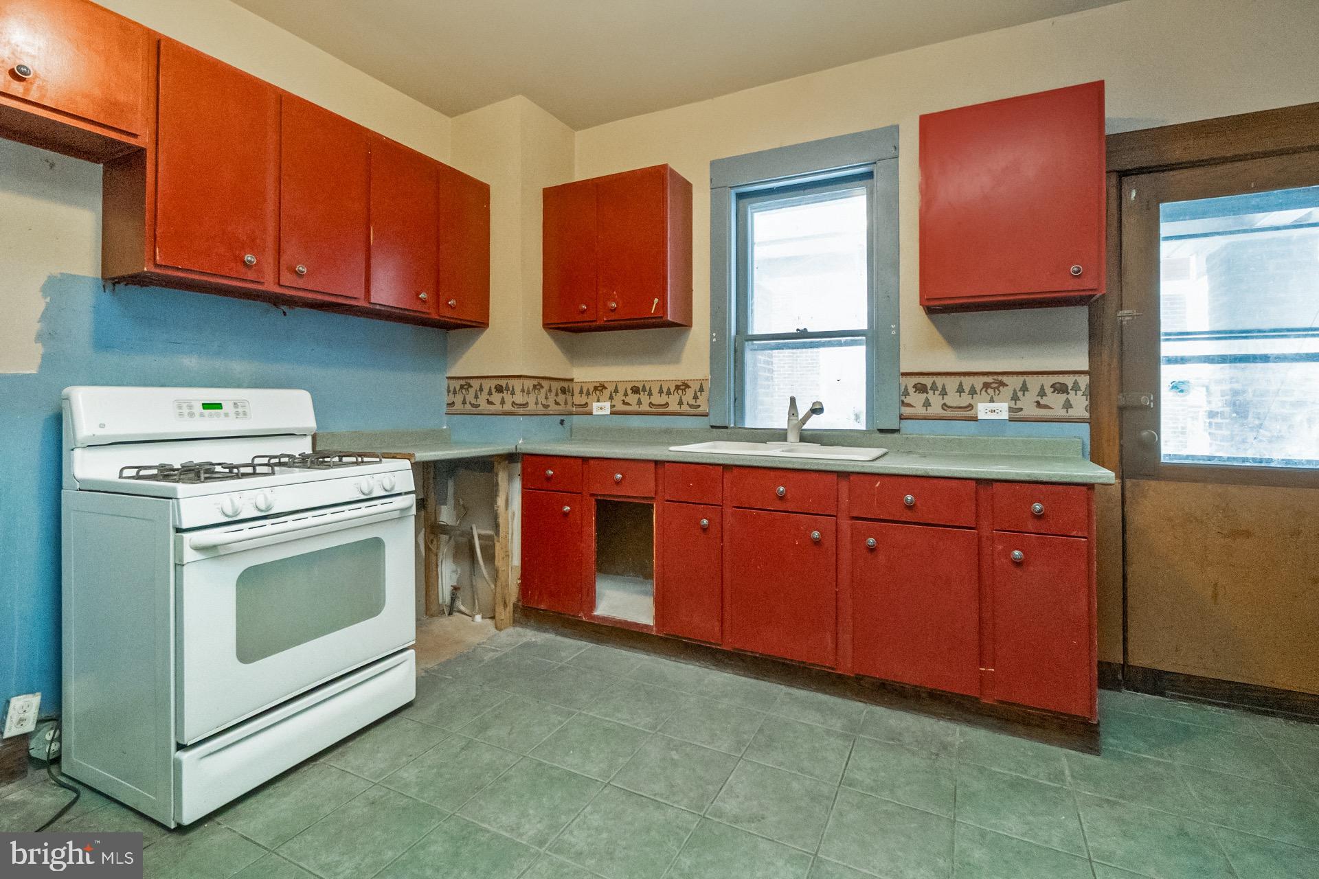 446 Williams Street Easton, PA 18042 - Photo 9 of 37 a kitchen with stainless steel appliances granite countertop a stove a sink and a microwave