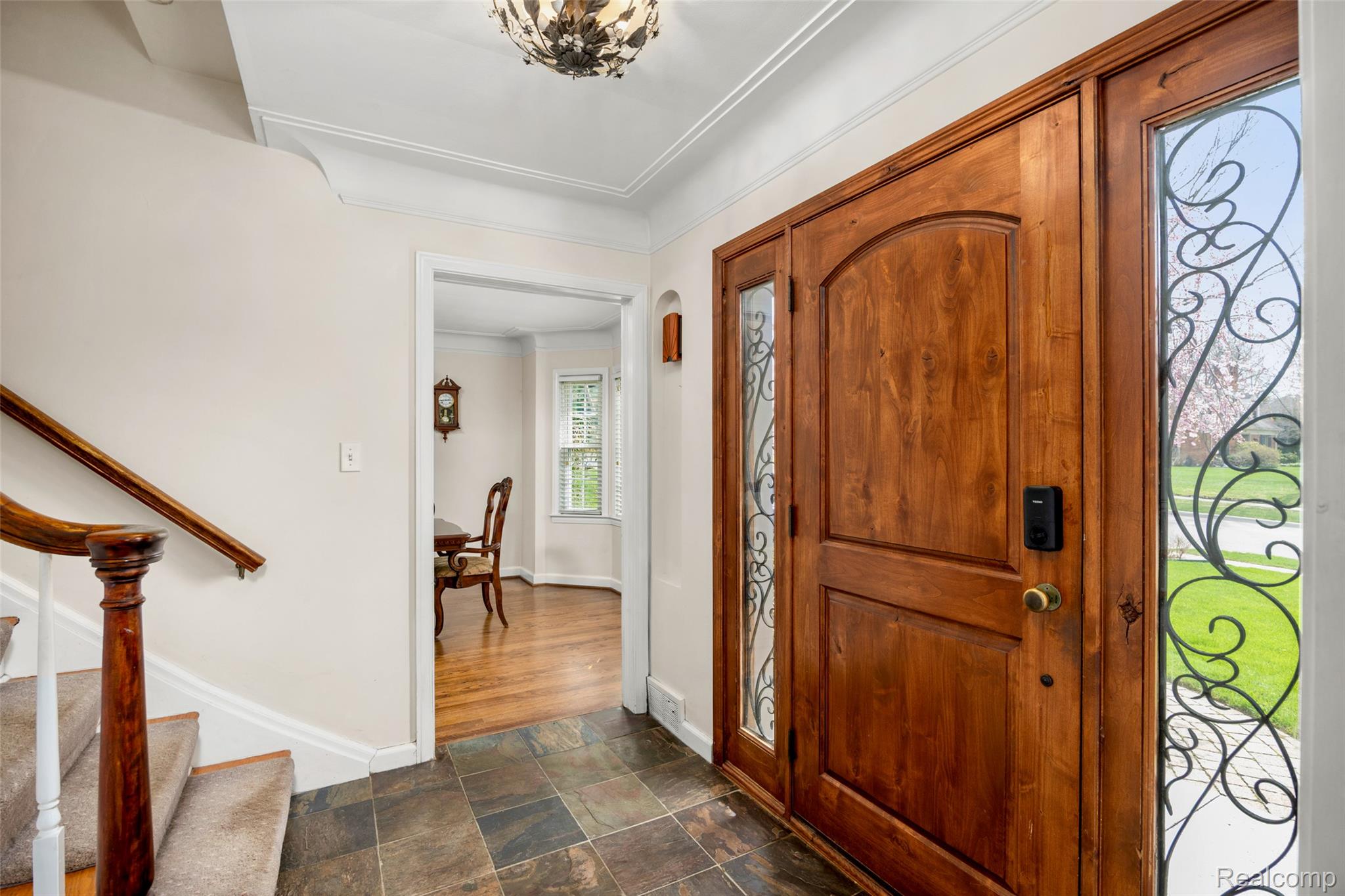 244 Kerby Road Grosse Pointe, MI 48236 - Photo 9 of 53 Foyer featuring stone finish floors, ornamental molding, and suspended lighting