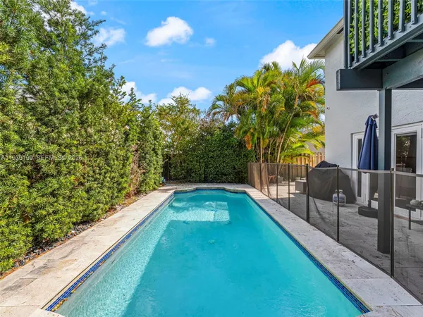 a view of swimming pool with seating space