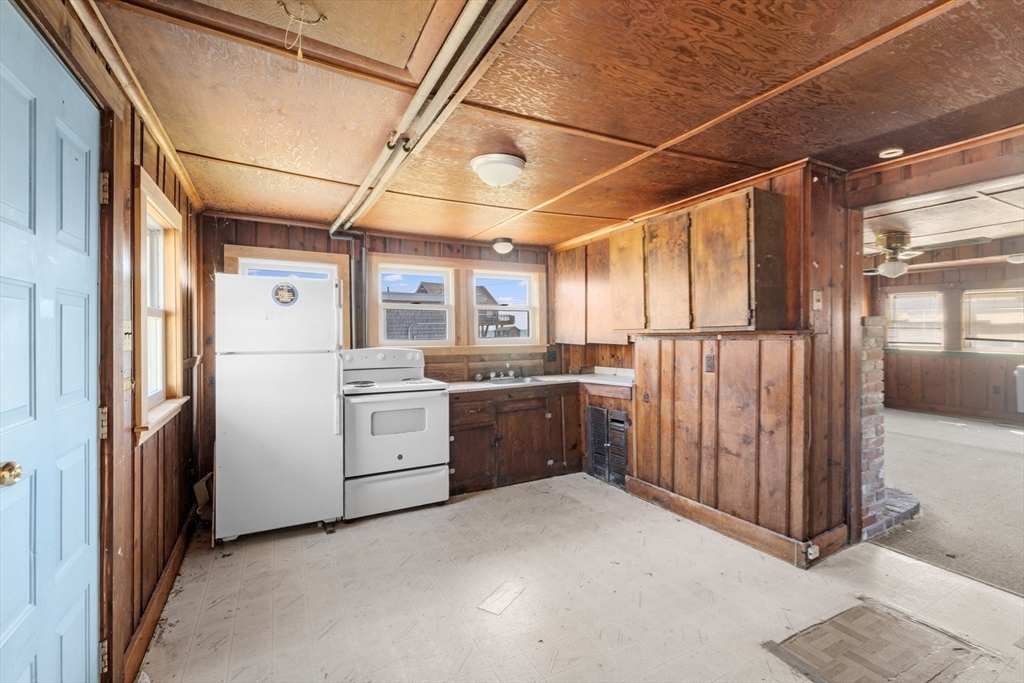 7 Silver Shell Beach Drive Fairhaven, MA 02719 - Photo 12 of 35 a kitchen with a refrigerator and white cabinets