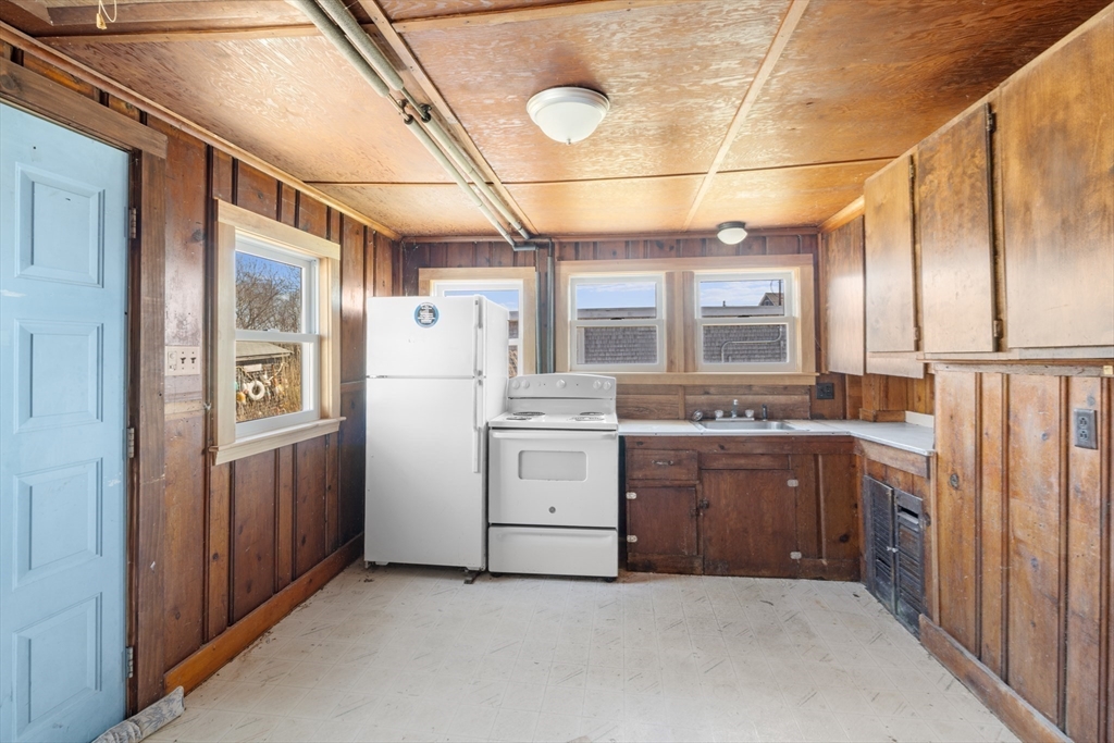 7 Silver Shell Beach Drive Fairhaven, MA 02719 - Photo 14 of 35 a kitchen with a refrigerator and a sink