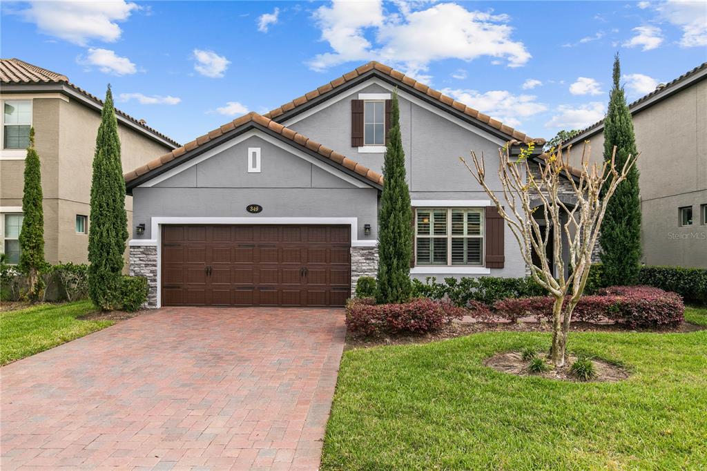 349 Ancona Avenue DeBary, FL 32713 - Photo 1 of 1 a front view of a house with a yard and garage