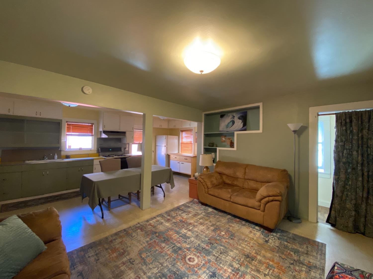 14105 River Road Walnut Grove, CA 95690 - Photo 20 of 41 a living room with furniture and a dining table with wooden floor