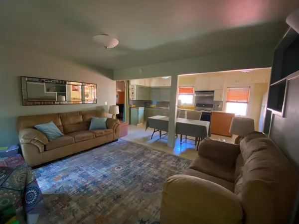 a bedroom with furniture and a flat screen tv