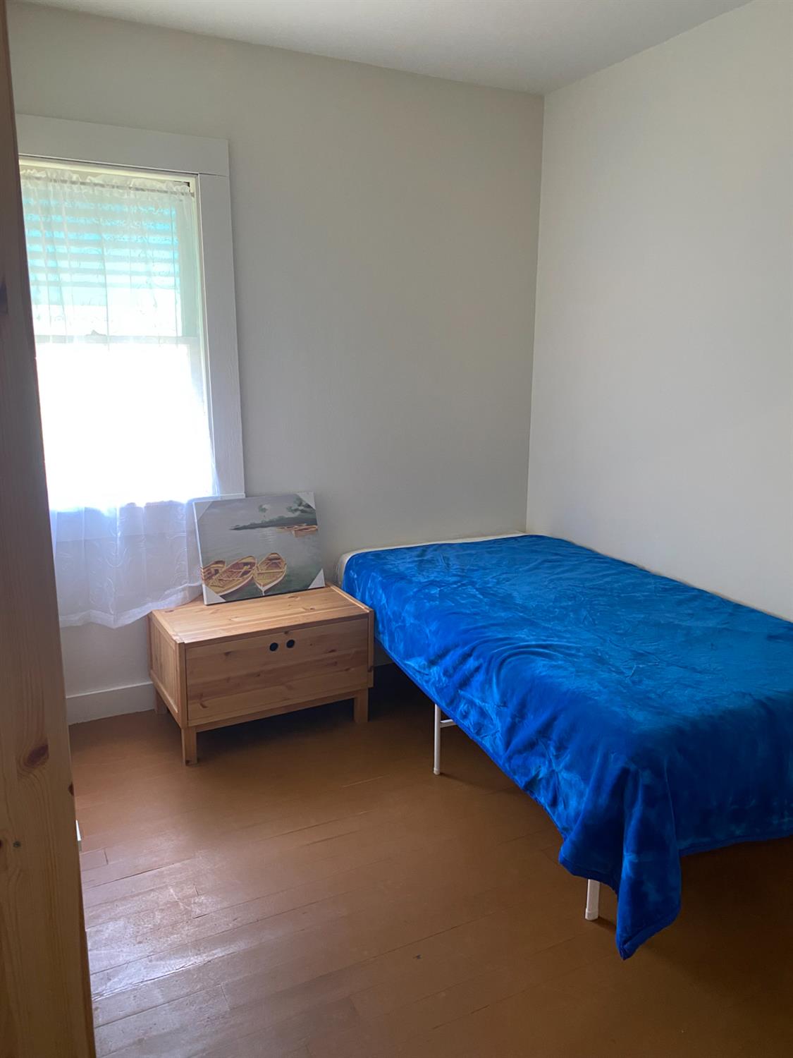 14105 River Road Walnut Grove, CA 95690 - Photo 8 of 41 a bathroom with a bed and wooden floor