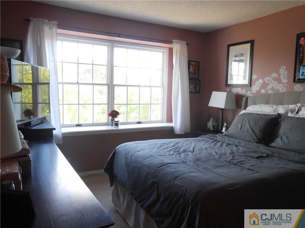 331 Edpas Road New Brunswick, NJ 08901 - Photo 5 of 15 a bedroom with a bed and wooden floor