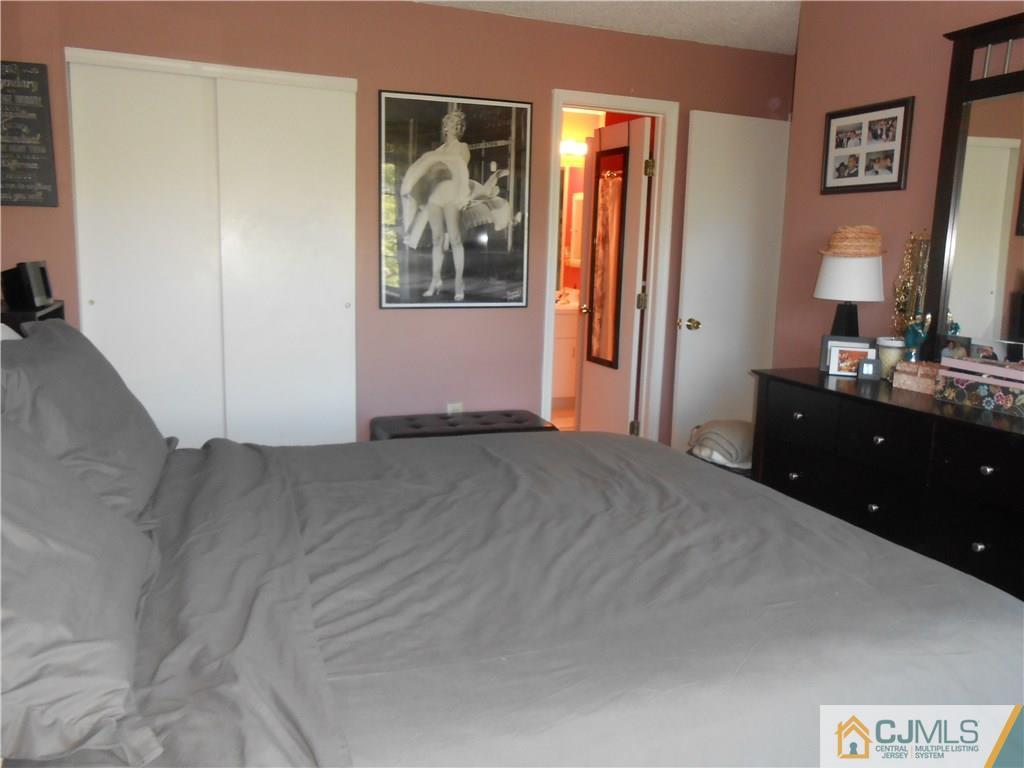 331 Edpas Road New Brunswick, NJ 08901 - Photo 6 of 15 a spacious bedroom with a bed and a mirror