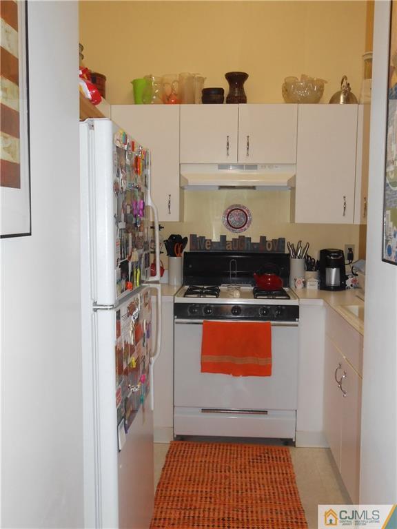 331 Edpas Road New Brunswick, NJ 08901 - Photo 9 of 15 a kitchen with stainless steel appliances granite countertop a refrigerator and a stove