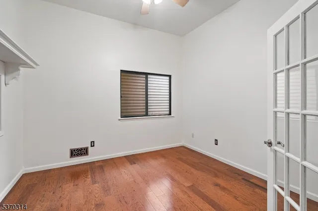 a view of a room with wooden floor and cabinet
