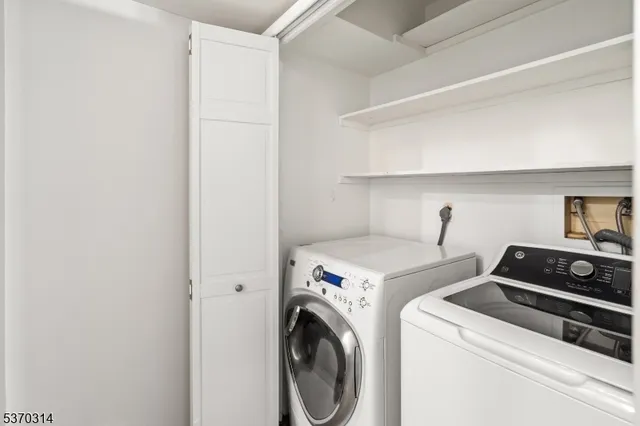 a view of washer and dryer with kitchen in the background