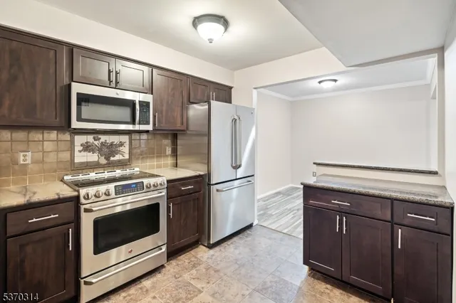 a kitchen with a stove microwave and refrigerator