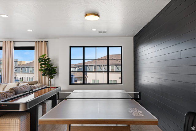 5367 Cyan Lane St. George, UT 84790 - Photo 20 of 49 Recreational room featuring a textured accent wall, wood-finish flooring, and recessed lighting