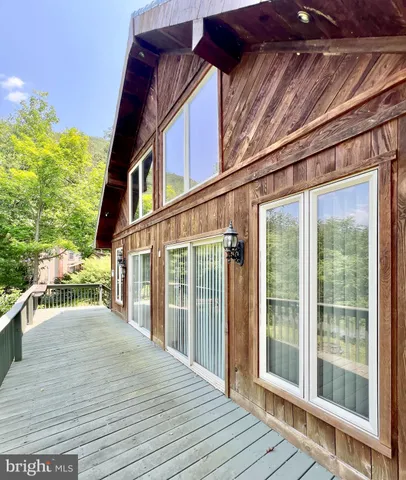 a view of balcony with wooden floor and fence